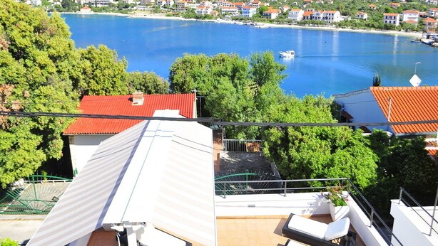 A rooftop terrace with outdoor seating and a view of a lake and surrounding buildings. - Villa with private swim pool, 40 meters from the sea (Seget Vranjica)