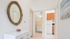 A modern kitchen with white cabinets and a white refrigerator. - Villa with private swim pool, 40 meters from the sea (Seget Vranjica)