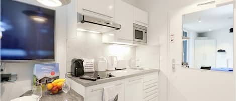 Fridge, stovetop, dishwasher, coffee/tea maker