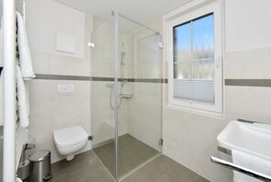 Shower, hair dryer, soap, toilet paper