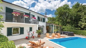 A two-story building with a swimming pool, outdoor seating, and exercise equipment. - Amazing home in Kamenmost with sauna (Kamenmost)