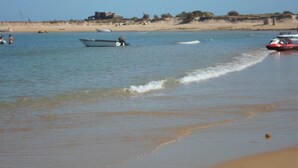 A beach with boats and a jet ski on the water. - Charming house in central Algarve in quiet highland, only 18 km to airport (Algarve)