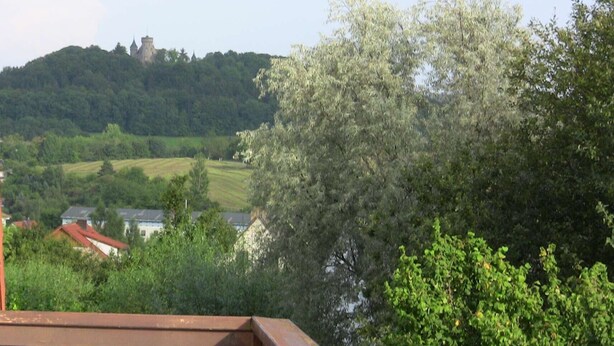 A view of a castle on a hill with surrounding greenery and houses. - quiet, attractive apartment with 2 bedrooms (Meiningen OT Walldorf)