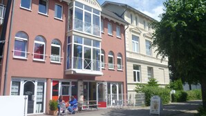 A two-story building with a prominent 'MATTEO' sign above the entrance. - Apartment stylish + cozy, in 3 minutes at the sea or in the center :) with parking space (Rostock)