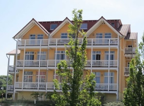 A multi-story building with balconies, likely a hotel or apartment complex.