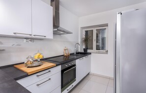 Fridge, stovetop, dishwasher, coffee/tea maker
