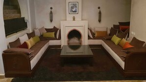 A living room with a fireplace, two sofas, and a coffee table. - Villa with pool in Marrakech (Marrakech)
