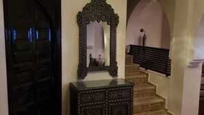 A staircase with a black railing, a dark wooden cabinet with a mirror, and a black door. - Villa with pool in Marrakech (Marrakech)