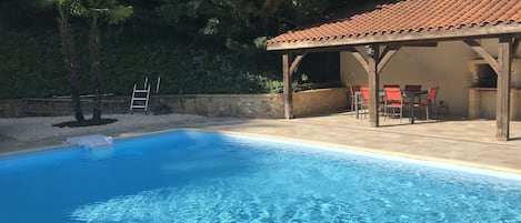 A heated pool, pool loungers