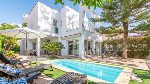 A modern house with a swimming pool, outdoor furniture, and a well-maintained garden. - Holiday Home "Villa Mar - Can Bujosa" on the Beach (Palma de Mallorca)