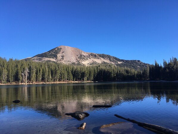 A mountain with a lake in the foreground.