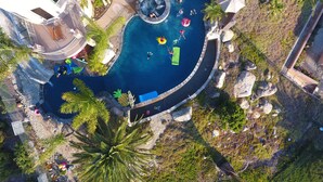 An aerial view of a resort with a large swimming pool, lounge areas, and tropical landscaping. - 10,000 ft² view estate with 7 Bdm Suites, Resort Pool, Theatre, Gym, Game Room! (Fallbrook)