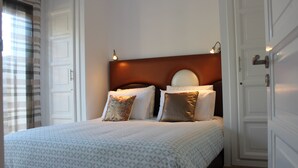 A neatly made bed with a patterned bedspread, a wooden headboard, and two bedside lamps. - VILLA "LOUISA" 4P-PRIVATE POOL GROUND FLOOR PARKING COMPLEX DYARSHEMSI  (Oulad Teima)