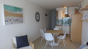 A compact living space with a dining area, kitchenette, and a bed. - Plage de Trestraou, Apartment facing the sea, 40 m² for 4 people, Wi Fi (Perros-Guirec)