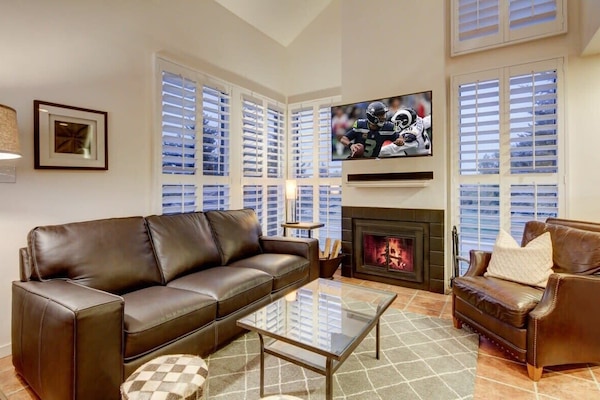 Great Room with fireplace, HDTV, tons of light - looks out to golf course. A great place to unwind with friends/family after an active day!