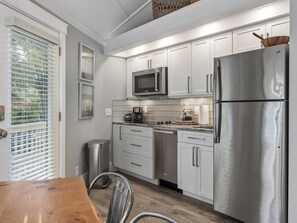 Enjoy cooking in this well-equipped kitchen with a refrigerator, microwave, and dishwasher.