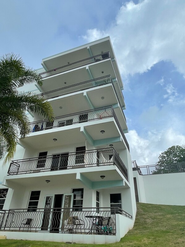 A multi-story building with balconies and a flat roof. - 2 BR/2BA Ocean View Poinciana Condominium (Puntas)