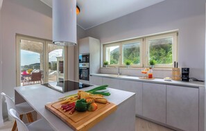 Fridge, stovetop, dishwasher, coffee/tea maker