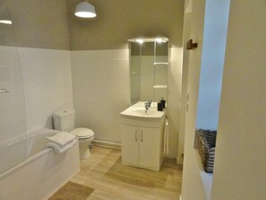 Bathtub, hair dryer, towels, soap