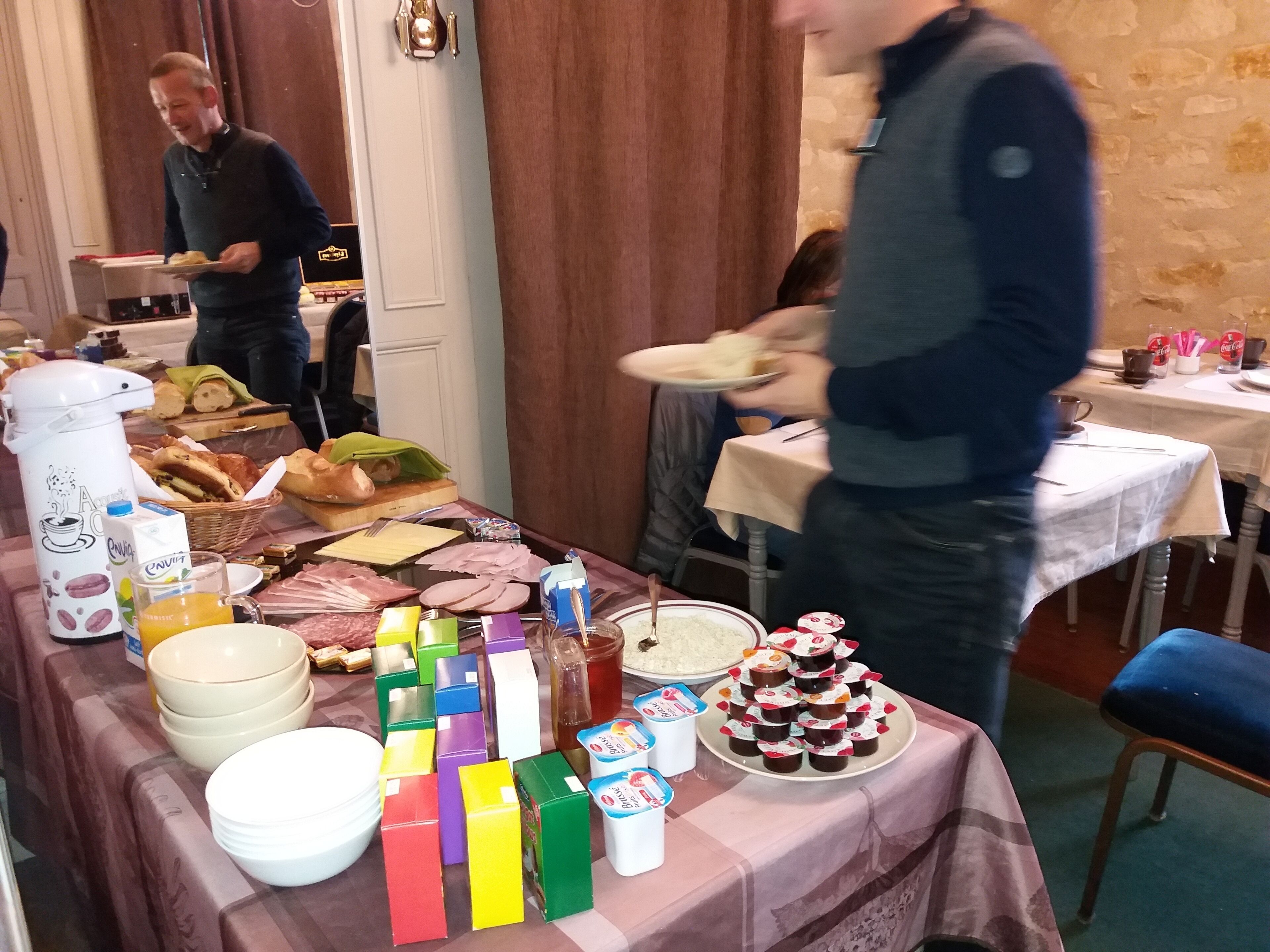 A buffet table with various food items and beverages.