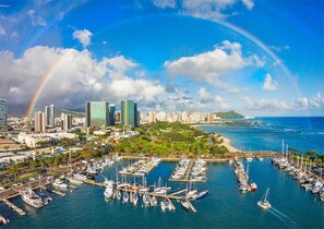 Overlooking a bustling marina with sailboats and yachts, this city offers stunning views of the surrounding landscape.