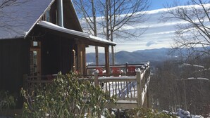 A wooden cabin with a balcony overlooking a snowy mountain landscape. - Cabin With A View (Burnsville)