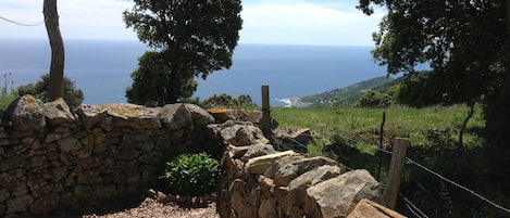 A stone wall with a view of the sea.