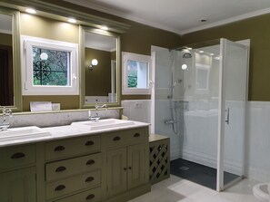 Een bad/douchecombinatie, een bubbelbad, een haardroger, een bidet