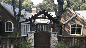 A house with a stone entrance, wooden gate, and a number '1866' on the wall. - Creekside Casita walking distance to downtown San Carlos (San Carlos)
