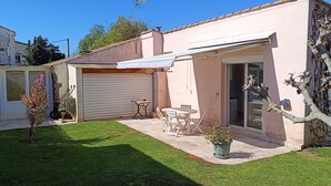 A house with a covered patio, a garage, and a small garden. - GITE FOR 4 PERS WITH POOL (Agde)