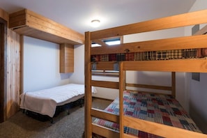 A bunk bed room with a wooden ceiling and a window. - 6-BR Teton View Ranch with Hot Tub (Driggs)
