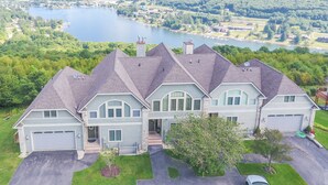 A large, multi-story house with a garage, a driveway, and a lawn. - Dog Friendly Deep Creek Escape w/ Mountain Views (McHenry)