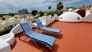 A rooftop terrace with two striped lounge chairs and a white dome structure. - Villa Robert. Smart detached Villa with communal pool and fully fenced garden (Calpe)