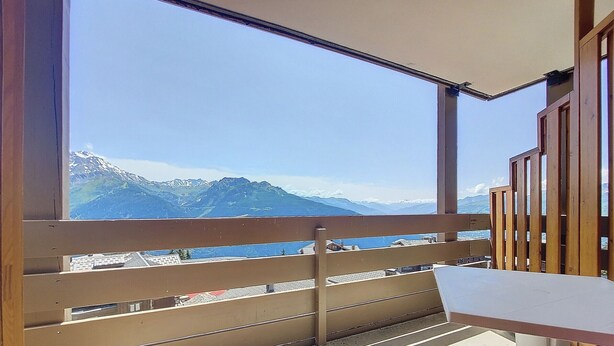 A balcony with a view of snow-capped mountains.