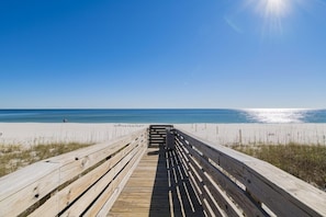 Walk along the boardwalk to the sandy beach.