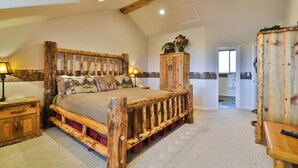 Een eenvoudige slaapkamer met een houten bed, een houten kast en een klein tafeltje.