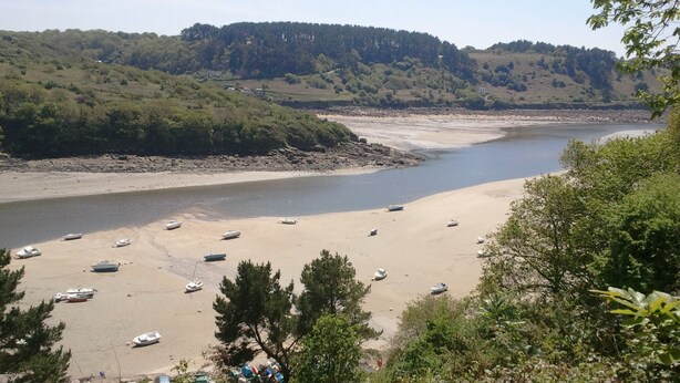 A beach with boats and cars parked on the sand, surrounded by greenery and hills. - House 800m from the beaches of Beg Leguer, with enclosed garden with trees (Lannion)