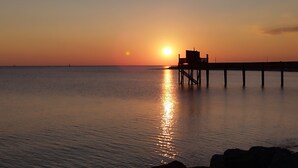 A pier extending into calm water at sunset. - Charming house Spa Terrace Garden (Angoulins)