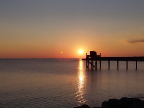 A pier extending into calm water at sunset. - Charming house Spa Terrace Garden (Angoulins)