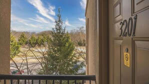 A building entrance with a door labeled "3201" and a yellow sign with a no-smoking symbol. - Mountain View Zodiac - Unit 3201 - FREE Attraction Ticket with EACH night Stay Including Dollywood (Pigeon Forge)