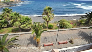 A coastal view with a stone pathway, benches, and palm trees. - New 2010 - 1 bdrm penthouse, ocean front, south and north facing terrace, luxury (Garachico)