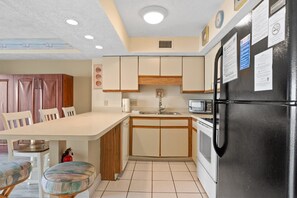 Enjoy meals in the kitchen with a central island, sink, and microwave, and dine at the adjacent table and chairs.