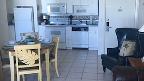 A compact living space with a dining area, kitchen, and a seating area. - Amazing! Direct Oceanfront Condo - Coconut Palms Beach Resort II* Special Rates* (New Smyrna Beach)