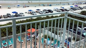 A balcony with a view of a beach and a pool area. - Amazing! Direct Oceanfront Condo - Coconut Palms Beach Resort II* Special Rates* (New Smyrna Beach)