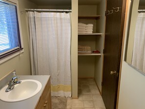 Shower, hair dryer, towels, toilet paper