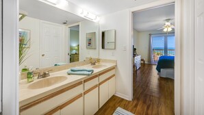 A bathroom with two sinks, a mirror, and a ceiling fan. - Beach Cottages Beachfront - Your Escape Awaits!   Sun, Secure, Family Friendly  (Indian Shores)