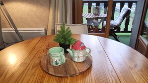 A round wooden table with a tray holding two mugs and a small potted plant. - Beautiful, independent, quiet apartment (Luz-Saint-Sauveur)