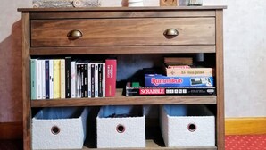 A wooden dresser with drawers, a mirror, and decorative items including candles and a vase with dried flowers. - Beautiful, independent, quiet apartment (Luz-Saint-Sauveur)
