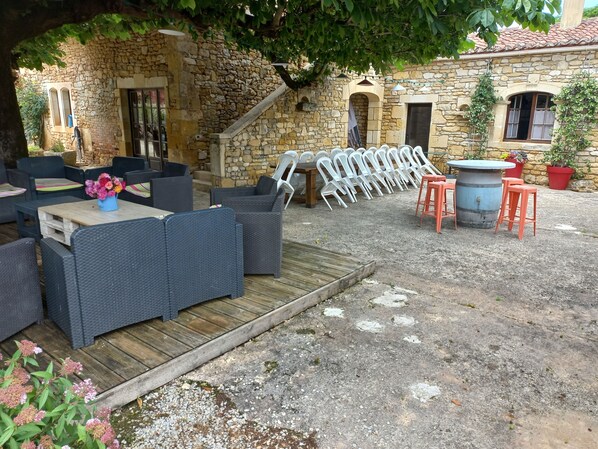 An outdoor seating area with wicker furniture and a wooden deck.