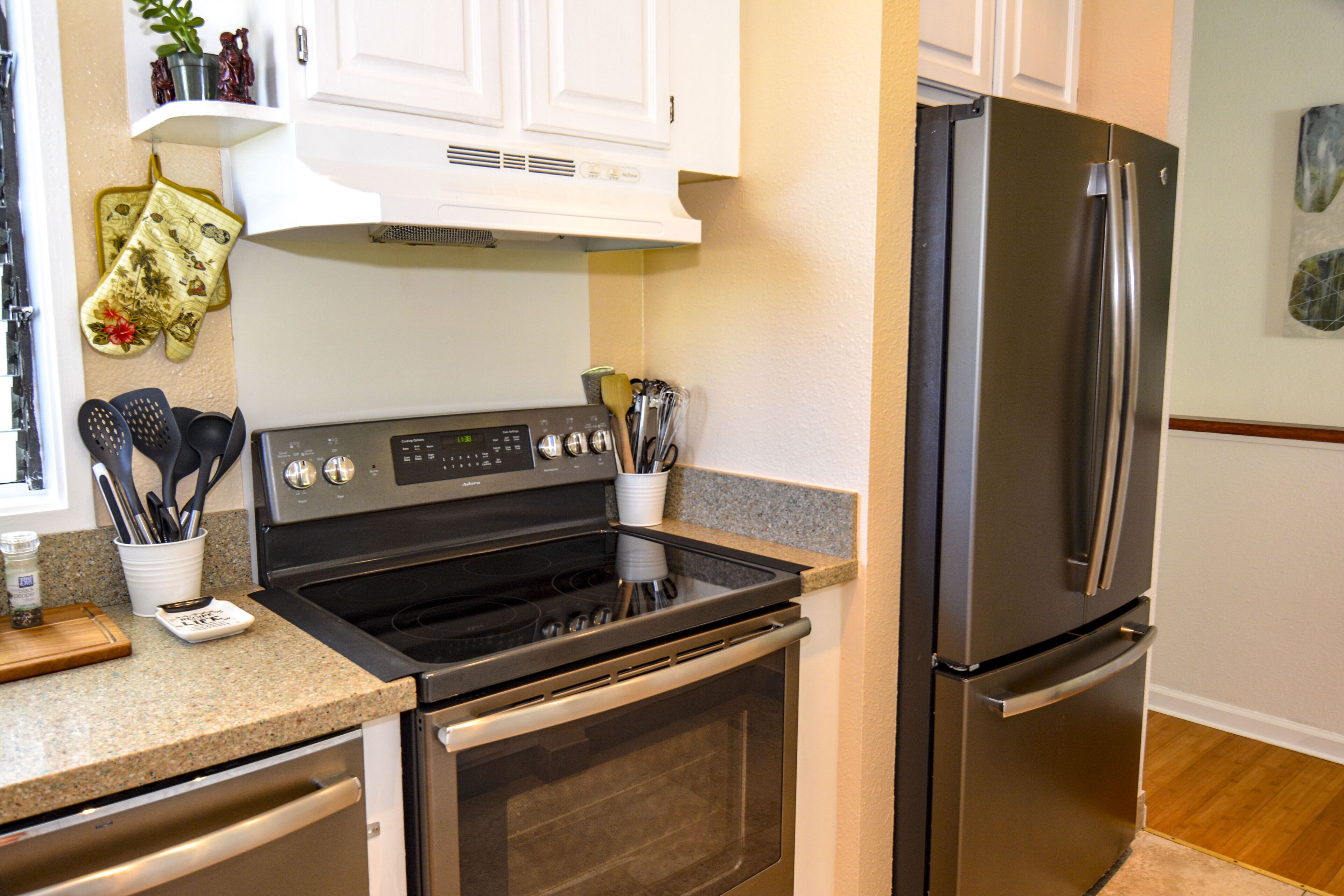 A kitchen with stainless steel appliances, including a stove, oven, and refrigerator.